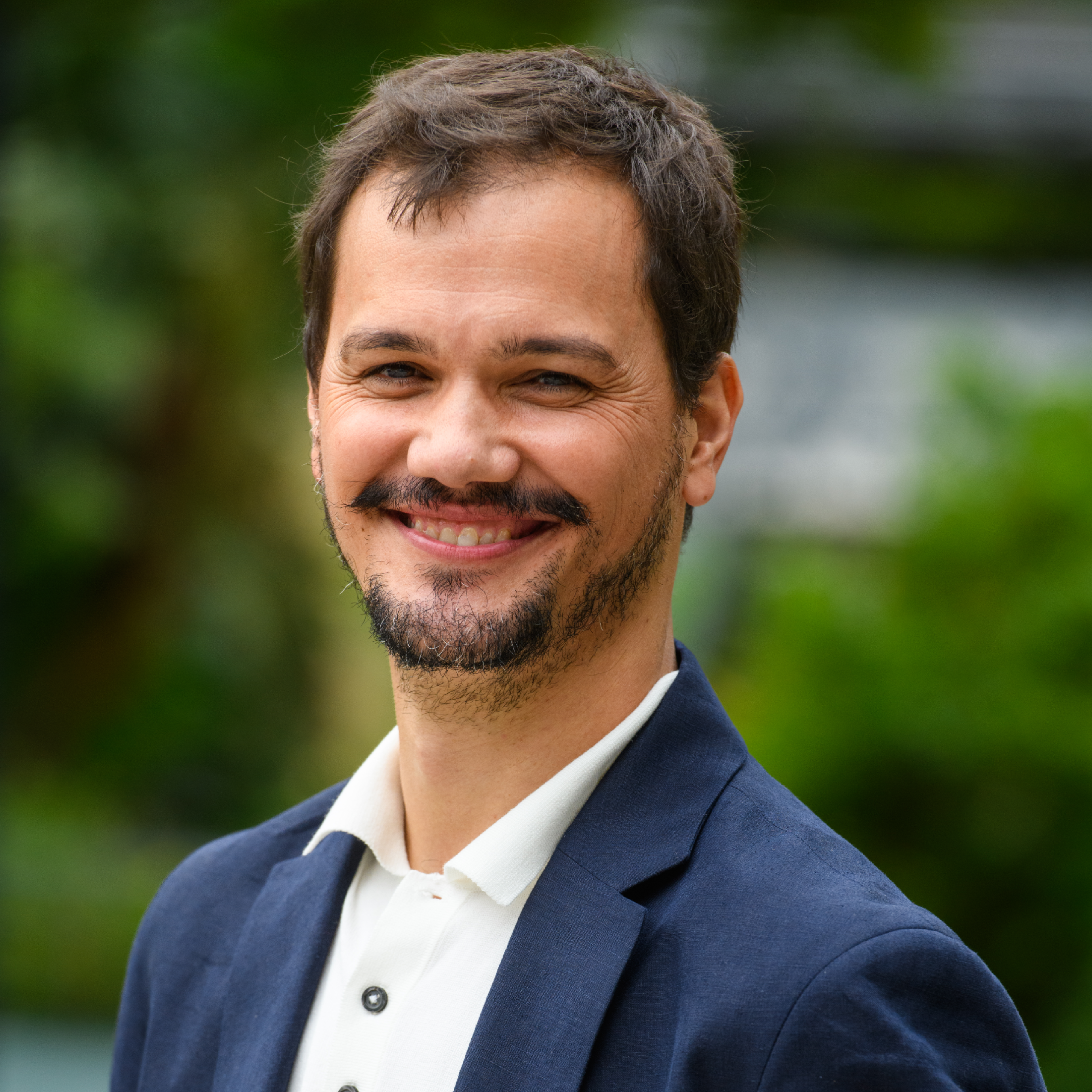A render of three white cylindrical columns, against a warm creme background
